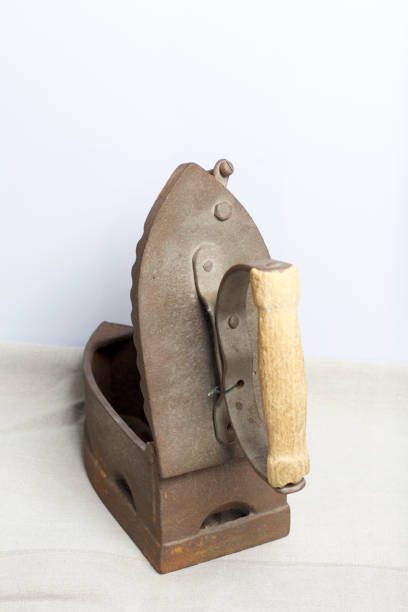 istock Old iron, heated by hot coals. Opened coal compartment. Located on linen fabric. 1097019818