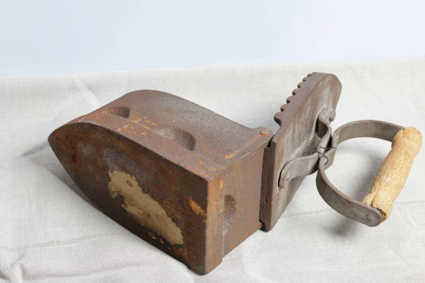istock Old iron, heated by hot coals. Opened coal compartment. Located on linen fabric. 1097019844