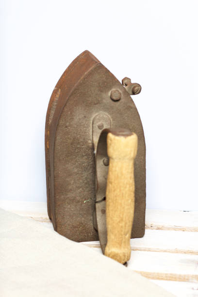 istock Old iron, heated by hot coals. Located on the a wooden box. 1097019848