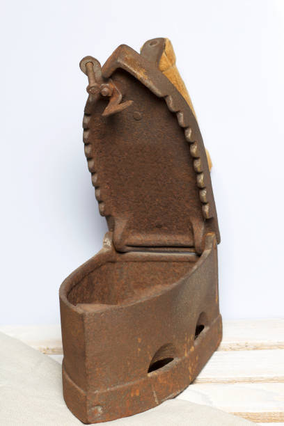 istock Old iron, heated by hot coals. Opened coal compartment. Located on the a wooden box. 1097019856