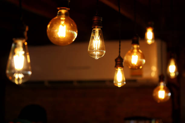 istock Low Angle View Of Illuminated Light Bulb Hanging From Ceiling 1097028662