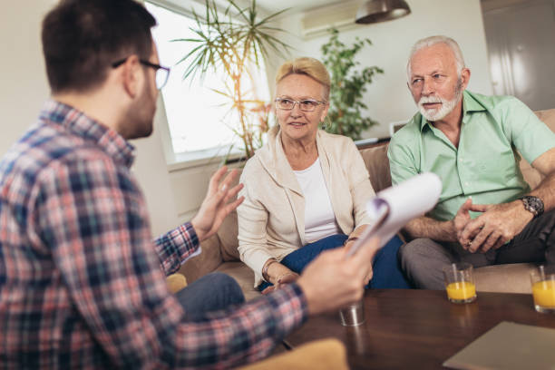 istock Positive aged couple consulting with insurance agent 1097031466