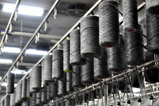 istock Low Angle View Of Thread Spools On Machinery In Industry 1097032192
