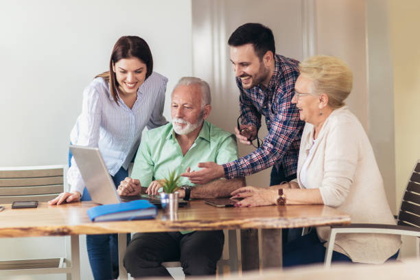istock Young volunteers help senior people on the computer 1097032424