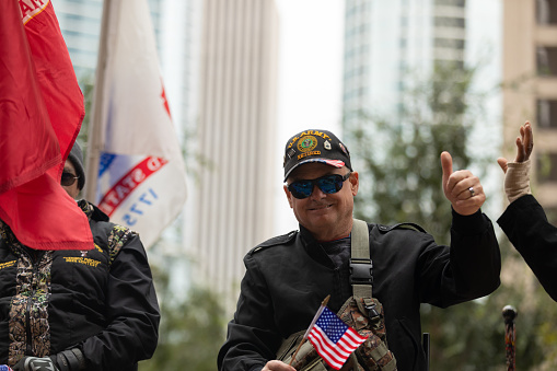 Houston, Texas, USA - November 11, 2018: The American Heroes Parade, A Dodge, Ram, pulling a trailer transporting Paralyzed Military veterans
