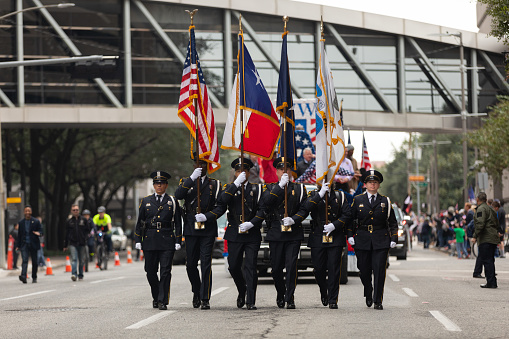Houston, Texas, USA - November 11, 2018: The American Heroes Parade, Police Officers in uniform, escorting the american flag down the street