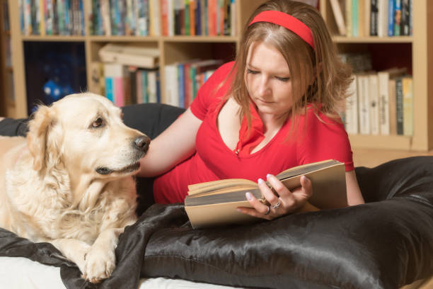 istock Relaxing with a dog and reading a book 1097057184