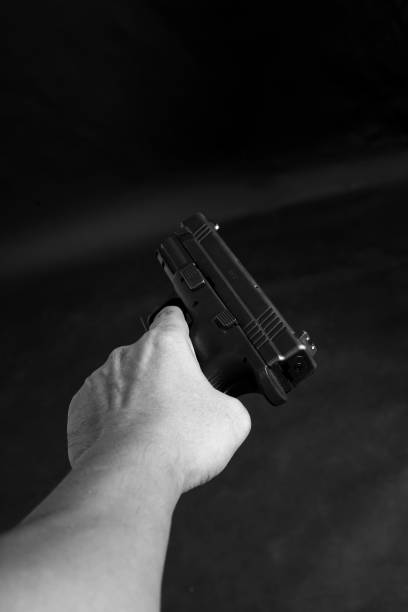 istock Man Holding a handgun and ready to shoot 1097058210
