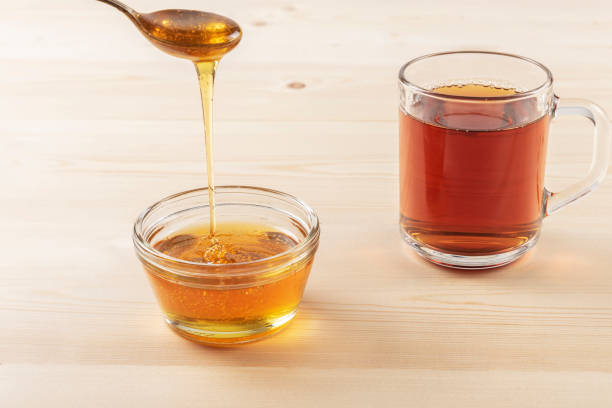 istock Honey in a jar on a wooden background 1097059552