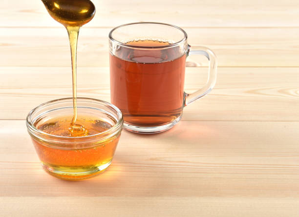istock Honey in a jar on a wooden background 1097059566