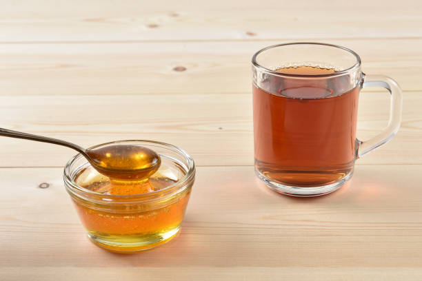 istock Honey in a jar on a wooden background 1097059586