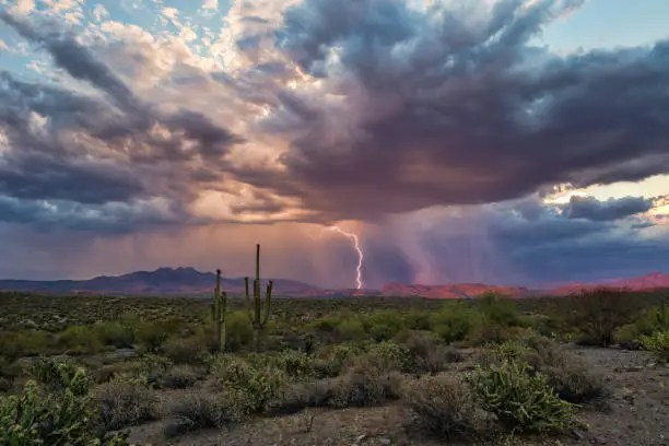 Dramatic sky with dark storm clouds and lightning in the Arizona desert.