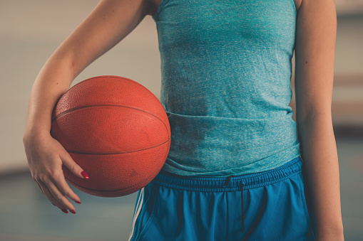 Fit woman holding a basketball ball