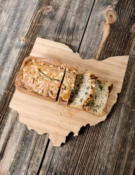Banana bread sliced and arranged on an Ohio shaped cutting board