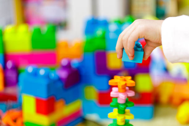 istock Children plastic color bricks with children hand. close up 1097064226