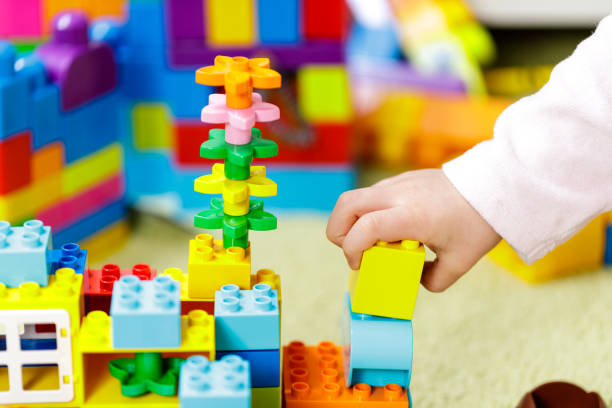 istock Children plastic color bricks with children hand. close up 1097064336