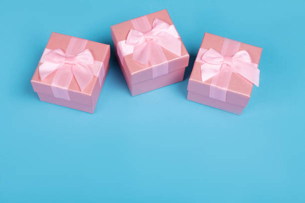 istock Gift or present box with pink bow ribbon  on blue background for Valentines day 1097064408