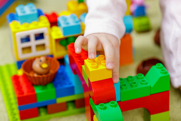 istock Children plastic color bricks with children hand. close up 1097064462