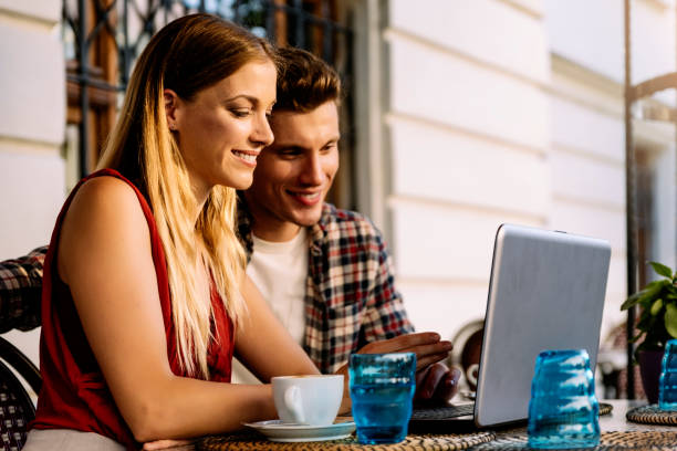 istock Happy couple at coffee shop using laptop. 1097064910