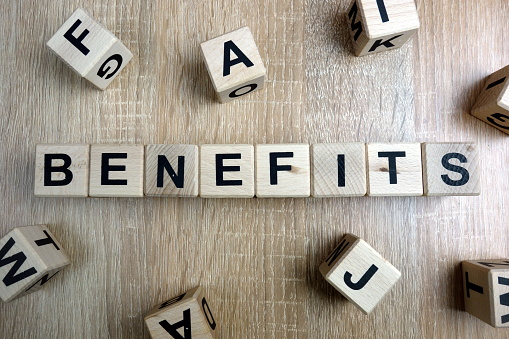 Benefits word from wooden blocks on desk