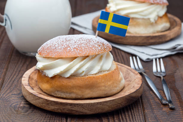 istock Traditional swedish dessert Semla, also called Shrove bun, with almond paste and whipped cream filling, served with milk, horizontal 1097080536