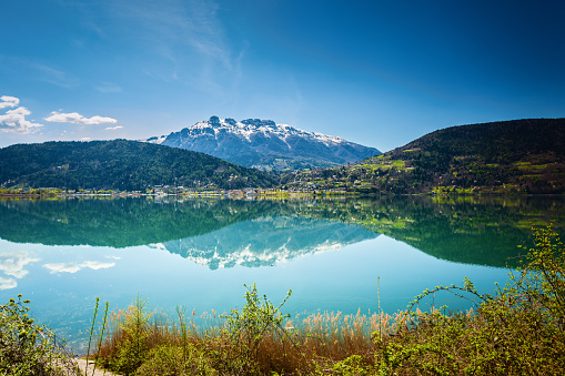 Lake Lago di Caldonazzo with Alps and slall town in Italy