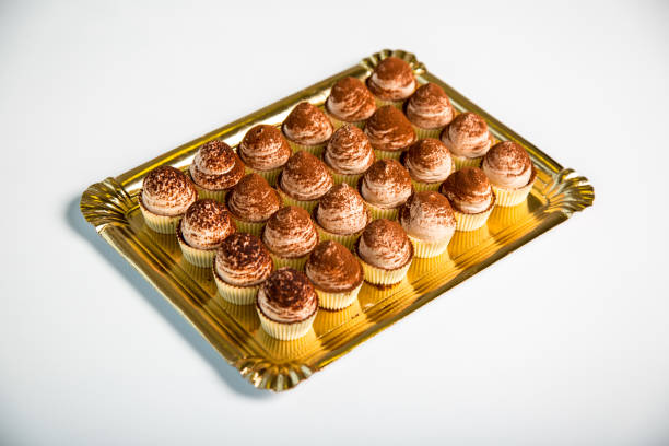 istock chocolate cupcakes in a tray on white background 1097089700