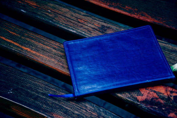 istock Notebook on bench in park, business concept 1097093682