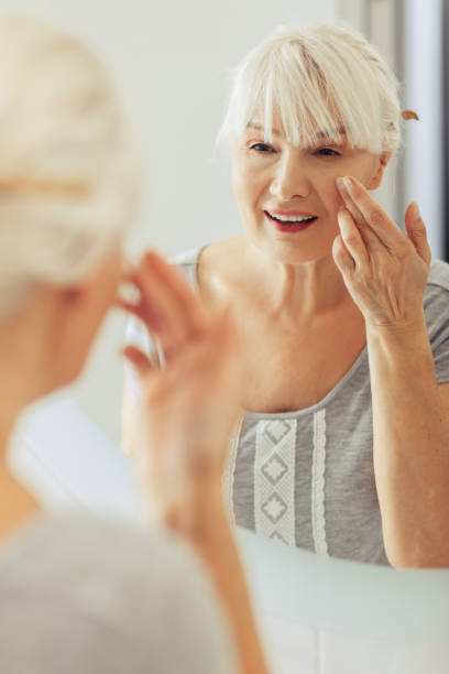 istock Nice aged woman caring about her skin 1097095034