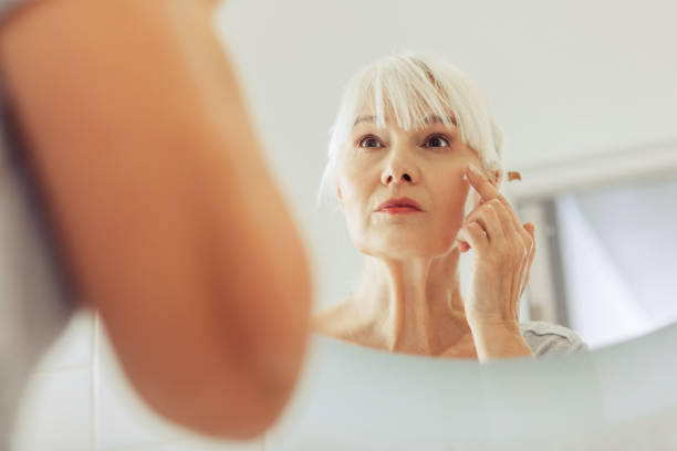 istock Mirror reflection of a nice aged woman 1097095046