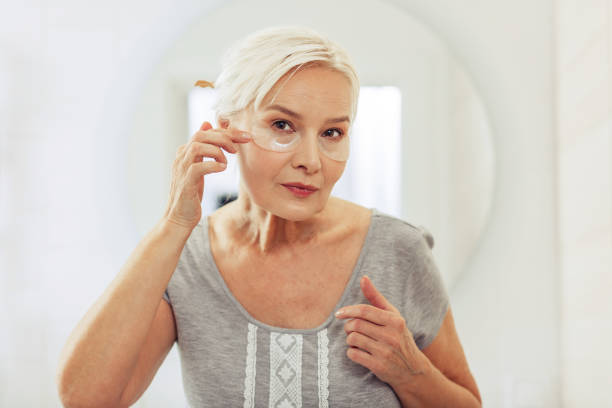 istock Pleasant aged woman looking at her face 1097095140