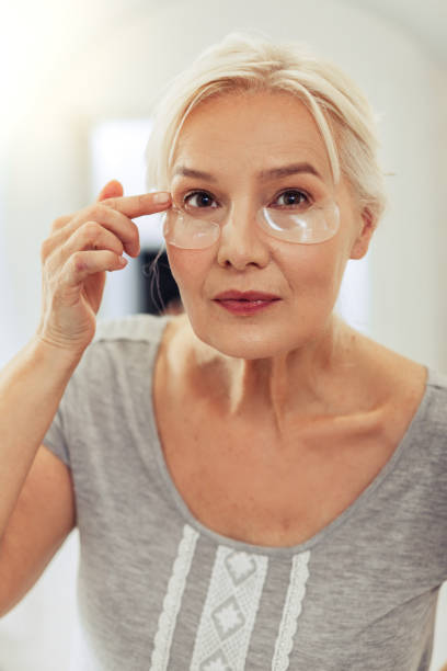 istock Pleasant elderly woman looking at her face in the mirror 1097095148