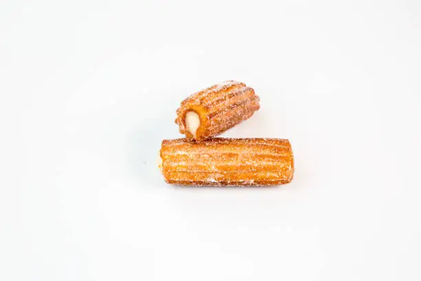 two sweet cream stuffed fritter churros with white background
