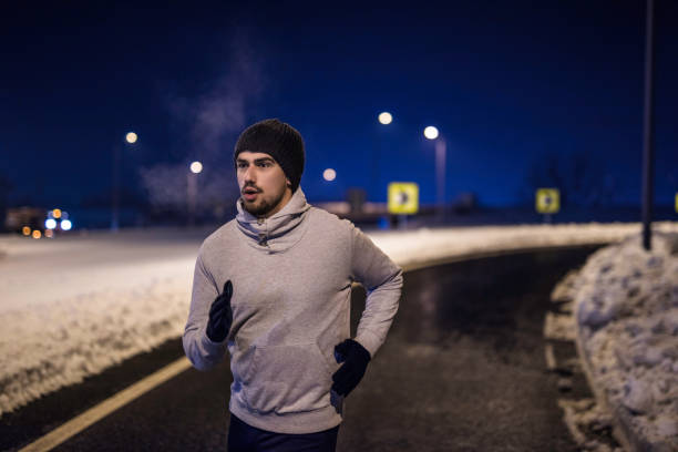 istock Young man running on a cold winter night. 1097096780