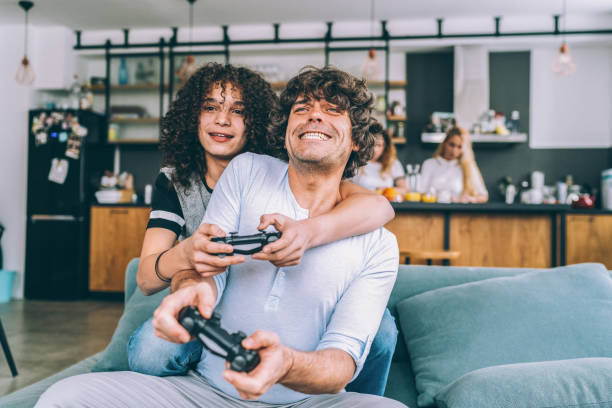 istock Father and son playing video game 1097098892
