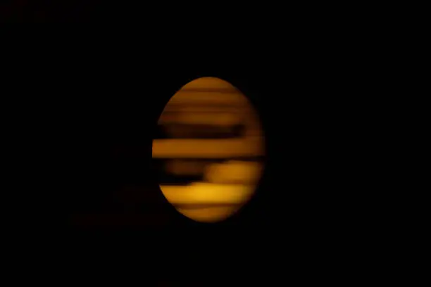Photo of Egg of light stripes on black background.