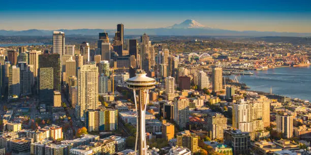 Aerial view of downtown Seattle, with the Space Needle and Mt. Rainier shot from helicopter