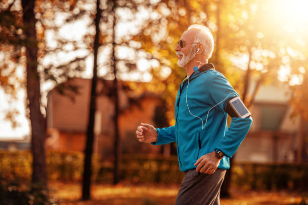 istock Attractive senior man jogging in the park 1097106652