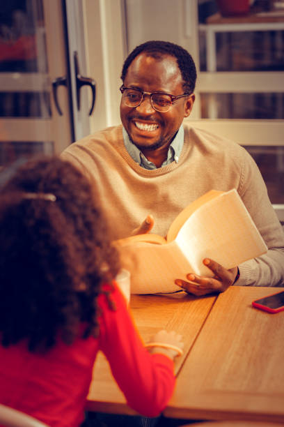 istock Cheerful African-American man laughing spending time with daughter 1097113544