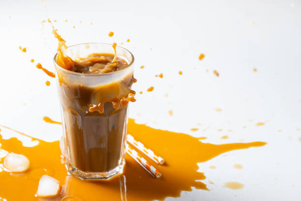 istock Iced latte coffee splash with ice cubes and roasted beans on a white background. With copy space 1097126254
