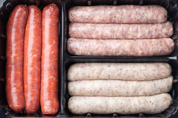 istock Close-up plastic tray with fresh raw pork and beef sausages. Top view 1097126280