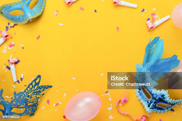 Table Top View Aerial Image Of Beautiful Colorful Carnival Festival Backgroundflat Lay Accessory Object The Mask Decor Confetti And Balloon On Modern Yellow Paper At Home Office Desk Studio Stock Photo - Download Image Now