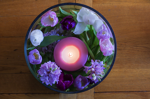 Candle with flowers in a vase