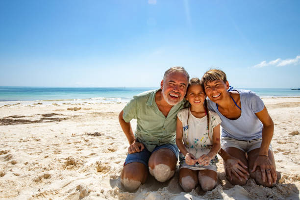 istock Happy Family Relaxing on Sandy Beach 1097136184
