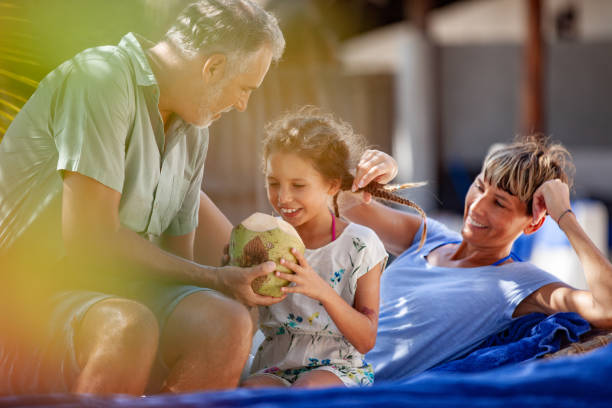 istock Family Drinking Coconut Juice on Tropical Vacations 1097136484