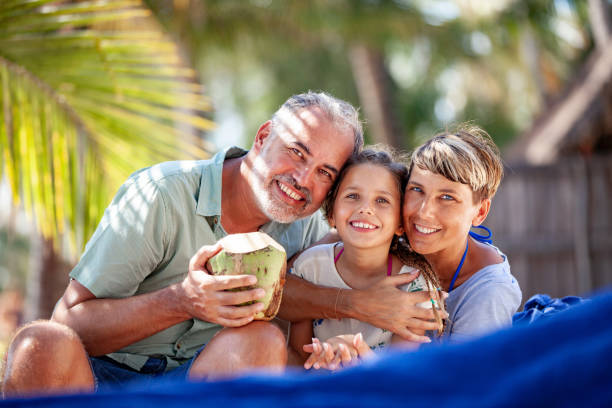 istock Family Drinking Coconut Juice on Tropical Vacations 1097136498