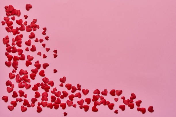 istock Valentines Day background. Red hearts on pink background. Copy space, top view. 1097140964