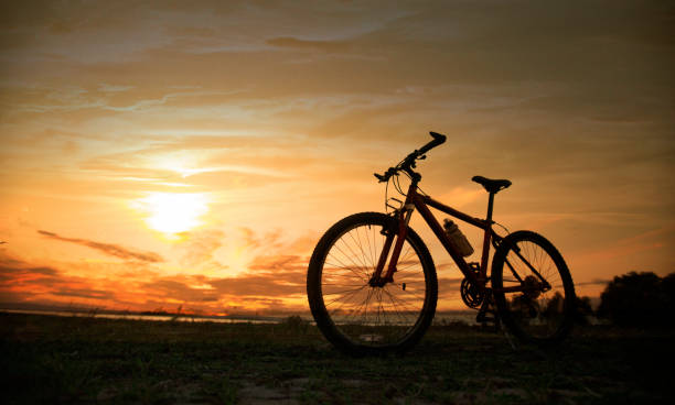 istock Silhouette bicycle with sunset or sunrise background 1097147972