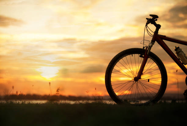 istock Silhouette bicycle with sunset or sunrise background 1097147974