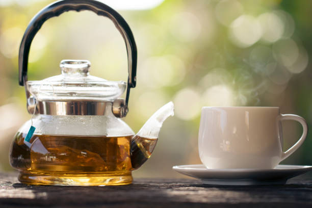 istock tea cup with tea pot on wood with nature background 1097154028